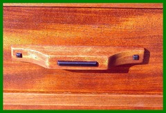 Close-up drawer pull with ebony detail.